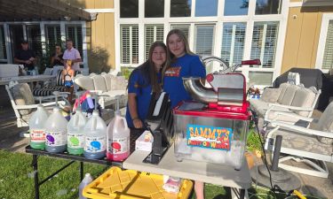 A child enjoying a colorful snow cone at a party