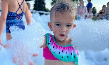 A girl enjoying the foam at a party