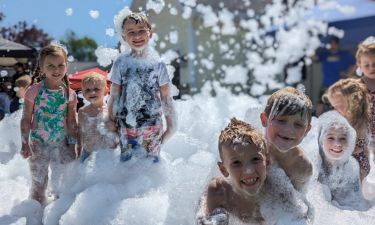 Children dancing in thick foam