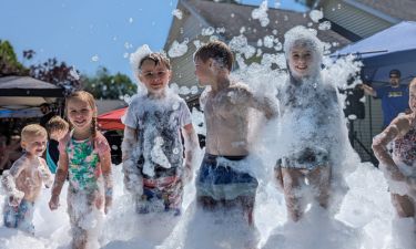 Children running through foam bubbles