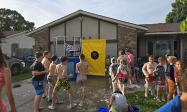 Kids lining up for a dunk tank at a foam party