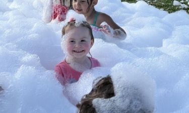 Child playing in foam at a foam party