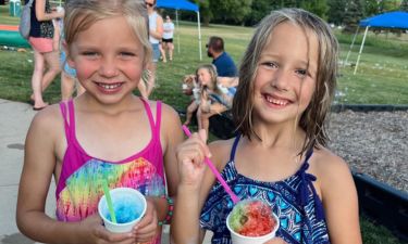 Children enjoying snow cones at a party