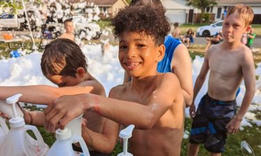 Children enjoying snow cones at an outdoor event.