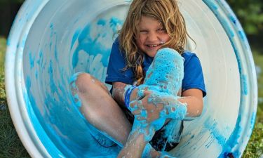 girl in a tube at a blue foam party