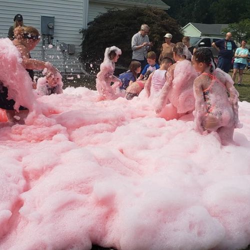 girls playing in pink foam at a birthday party