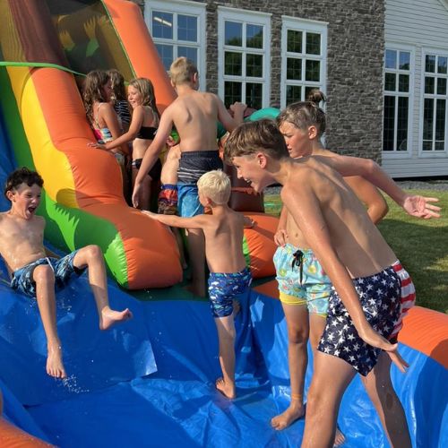 kids playing on a water slide in grand rapids michigan