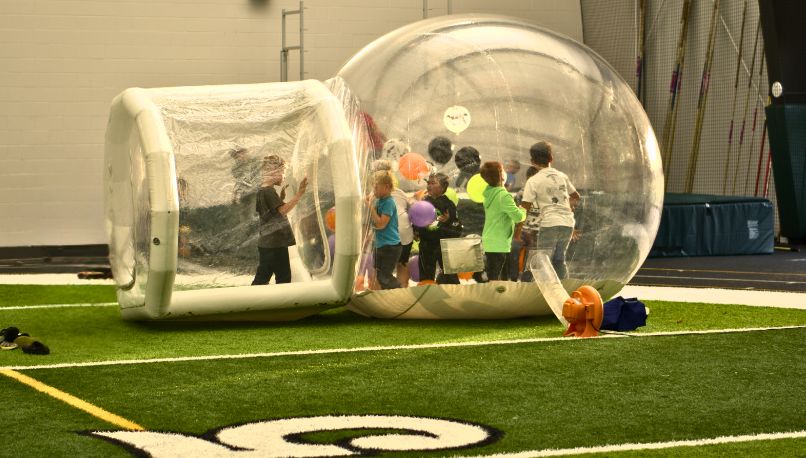 Children enjoying a Sammy's Party on Wheels events in a giant inflatable bubble.